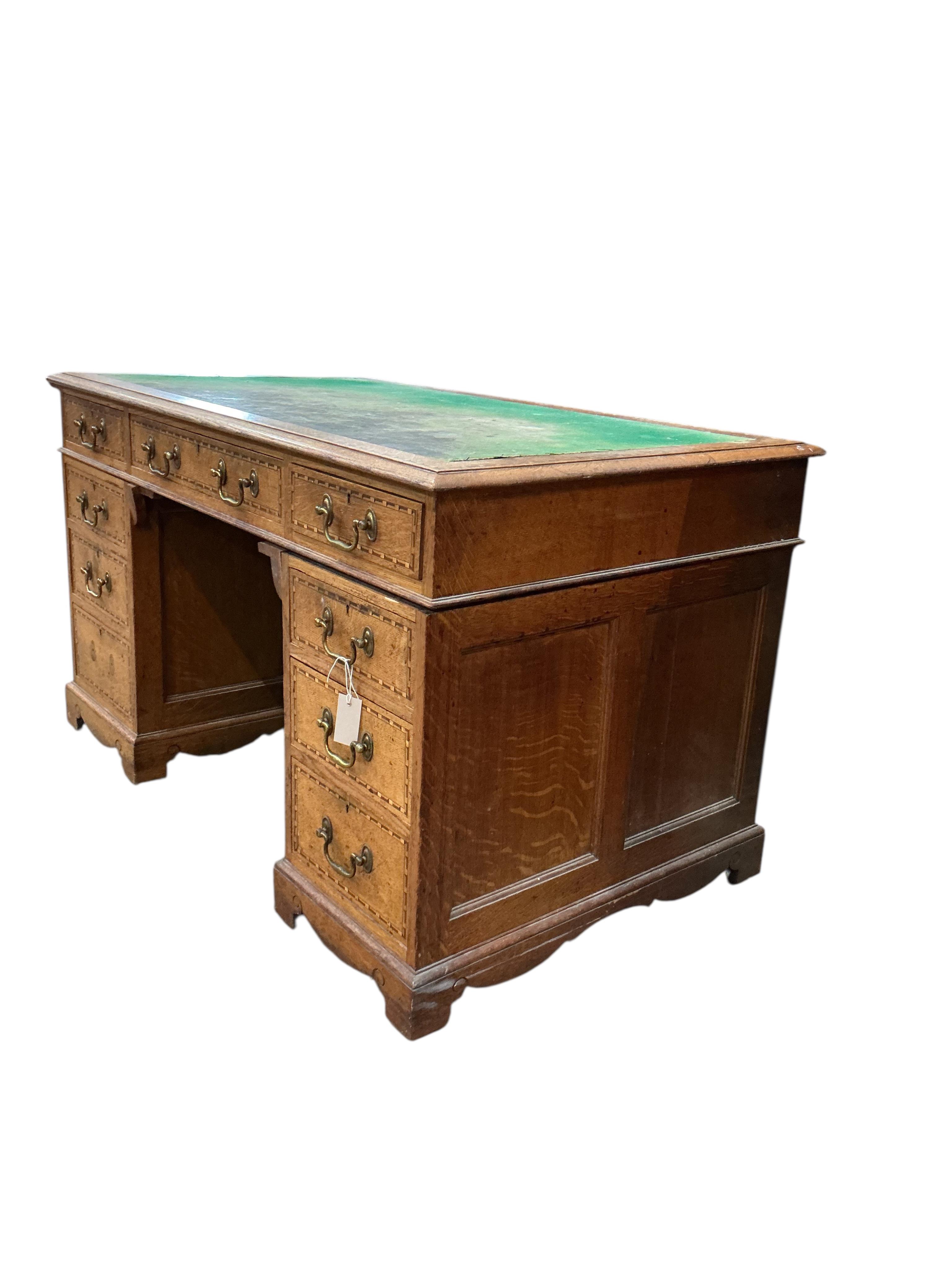 A late Victorian parquetry inlaid oak pedestal desk bears ivorine label Robson & Sons, Newcastle-on-Tyne, width 129cm, depth 76cm, height 76cm